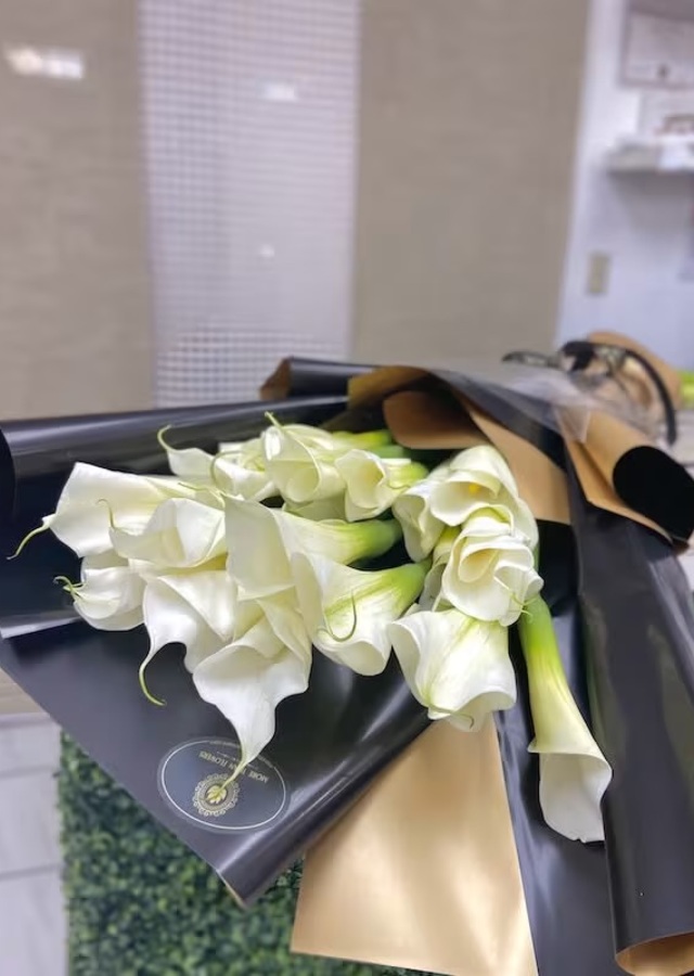 Display of Calla Lily Wrapped Bouquet by The Flower Alley